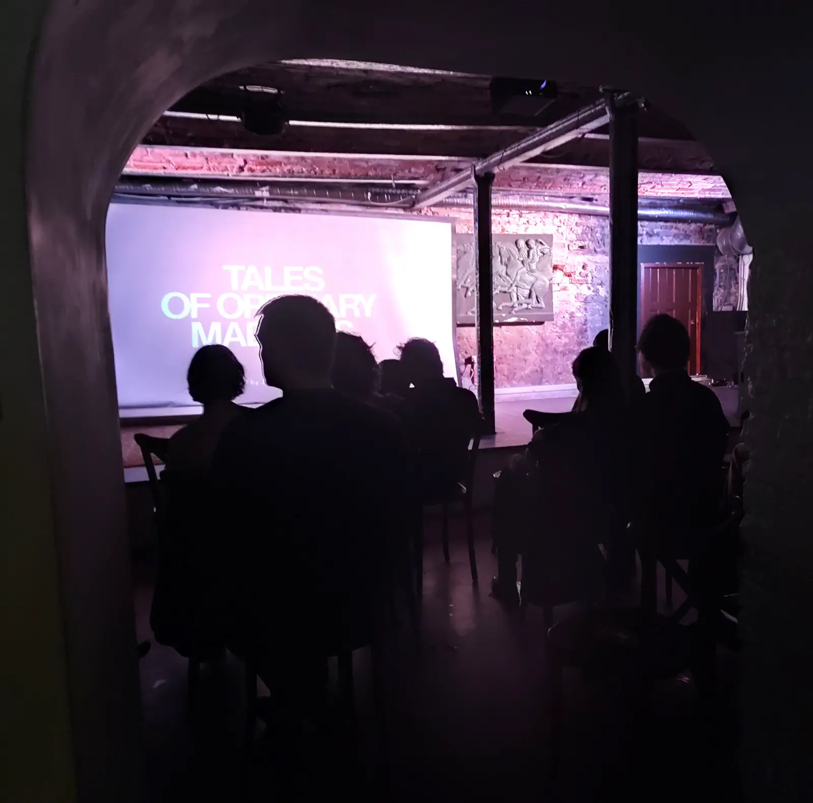 Audience watching a screening through an archway at the 2025 event.