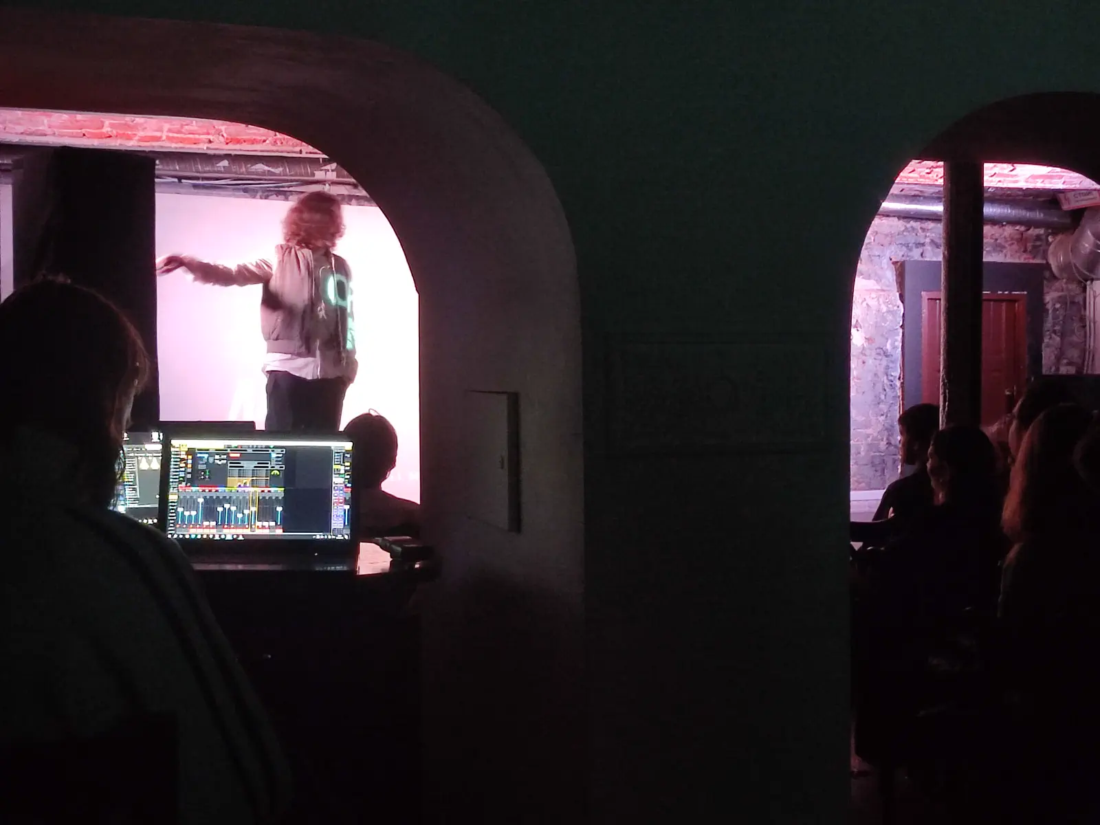 A performer or speaker framed by arches during the 2025 event.